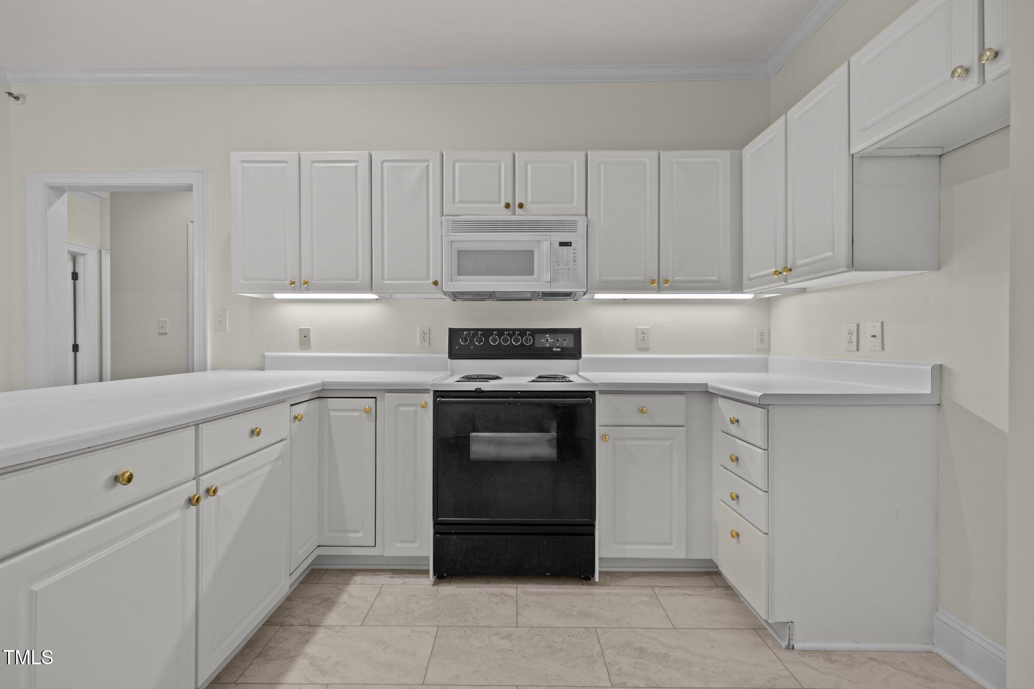 100 Edenburgh Road, Unit 202 Raleigh, NC 27608 - Photo 30 of 52 a kitchen with cabinets appliances and a counter space