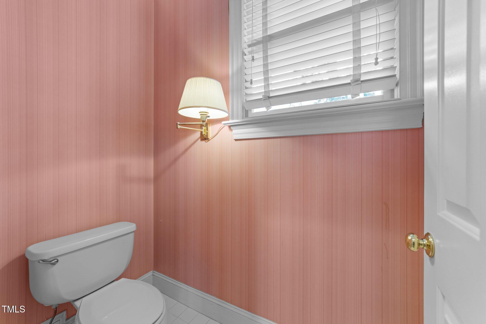 100 Edenburgh Road, Unit 202 Raleigh, NC 27608 - Photo 39 of 52 a bathroom with a toilet a sink and mirror