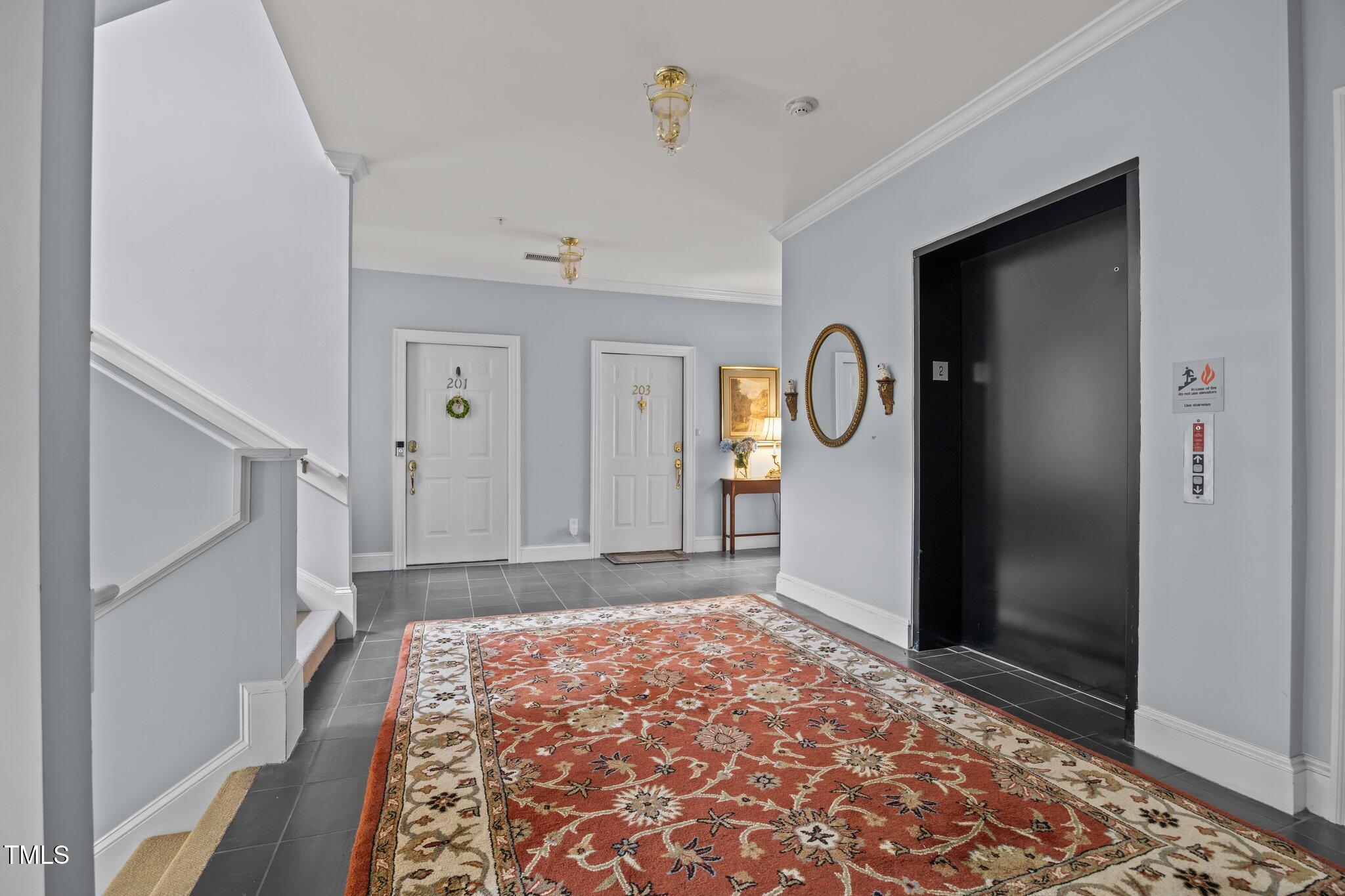 100 Edenburgh Road, Unit 202 Raleigh, NC 27608 - Photo 6 of 52 a view of a hallway view with wooden floor and a rug