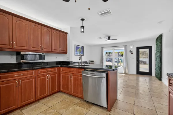 a kitchen with stainless steel appliances granite countertop a refrigerator and a stove top oven