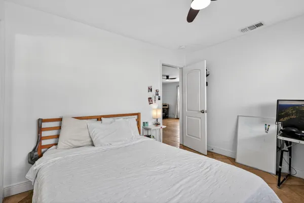 a bedroom with a bed and a window