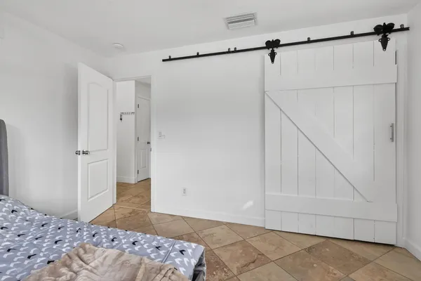 a bedroom with a bed and a wall painting