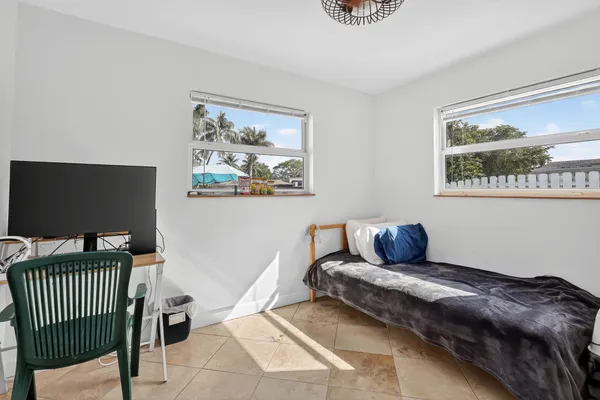 a bedroom with a bed and painting on the wall