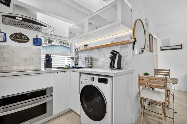 a close view of a sink and washer in a kitchen