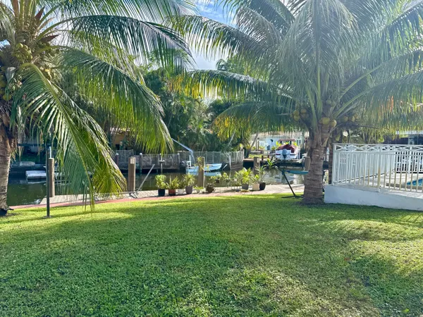 a view of backyard with a garden and deck