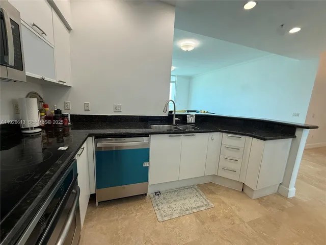 a kitchen with granite countertop a stove and a sink