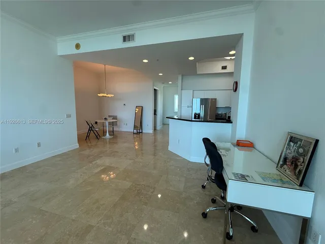 a living room with furniture and a dining table with kitchen view