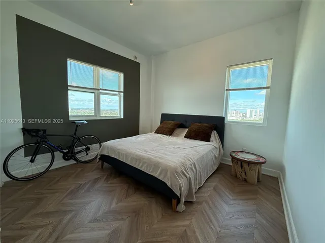 a bedroom with a bed and window