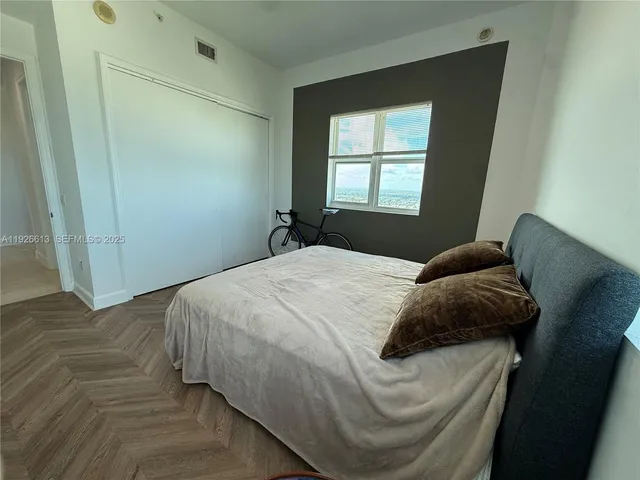 a bedroom with a bed and window