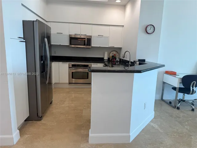 a kitchen with stainless steel appliances a sink stove and refrigerator