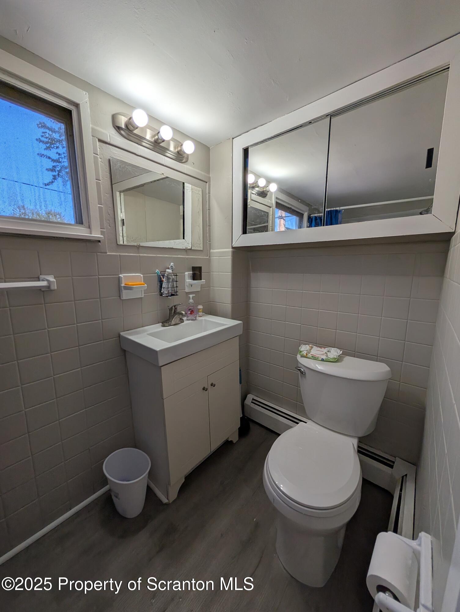 2133-2135 Jackson Street Scranton, PA 18504 - Photo 11 of 38 a bathroom with a toilet sink and mirror