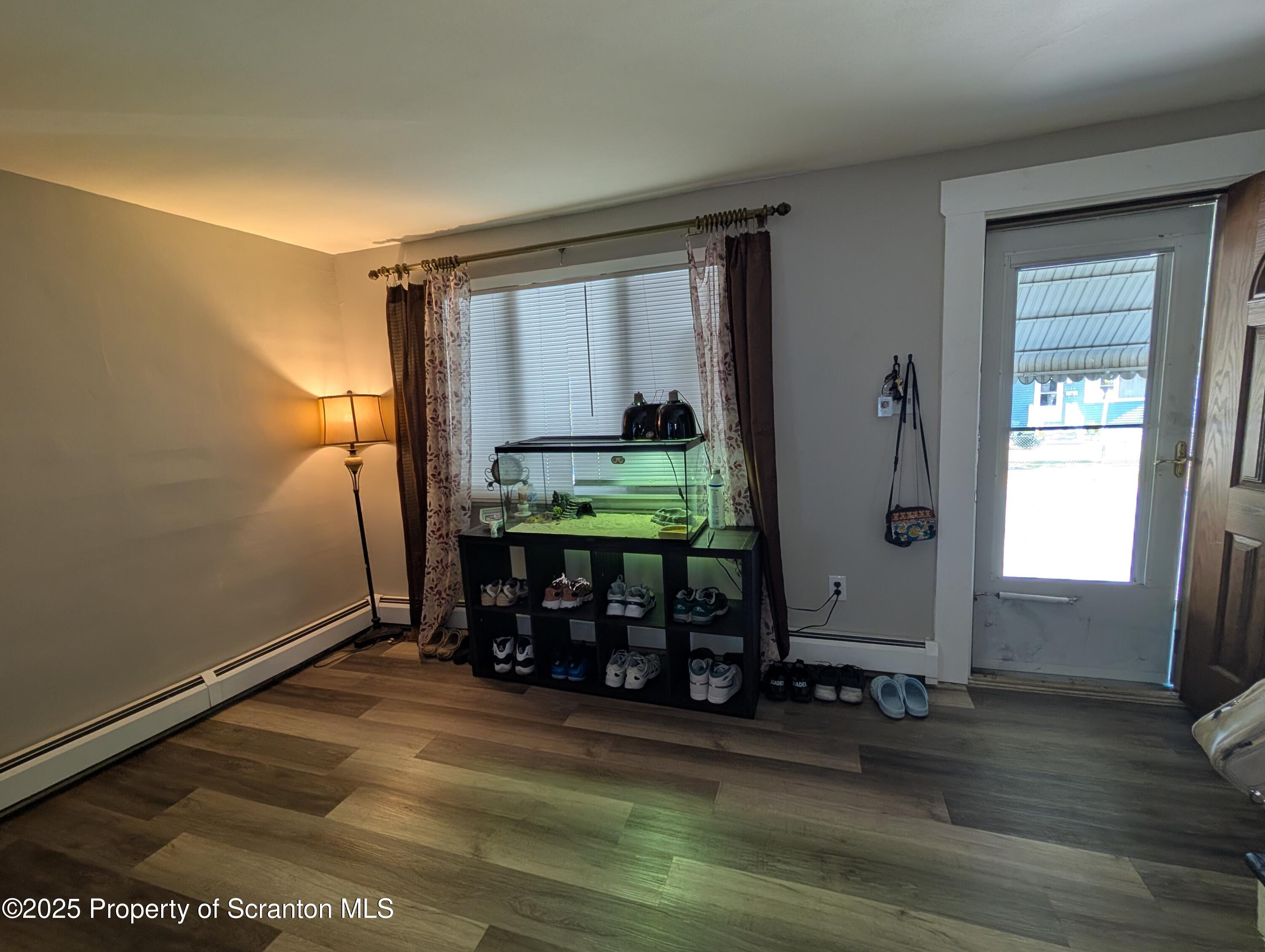 2133-2135 Jackson Street Scranton, PA 18504 - Photo 2 of 38 a room with wooden floor and windows