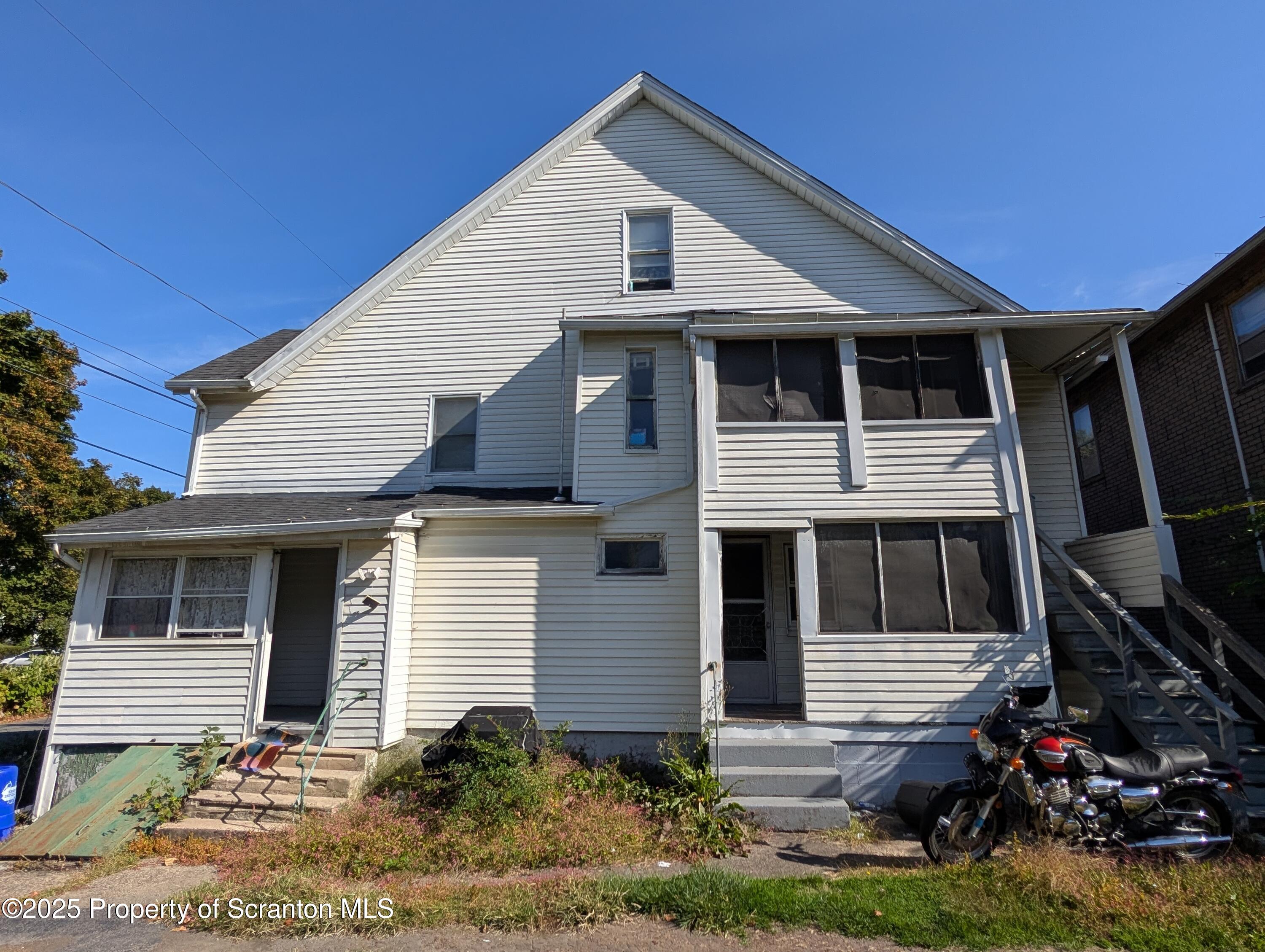 2133-2135 Jackson Street Scranton, PA 18504 - Photo 37 of 38 a front view of a house with garden