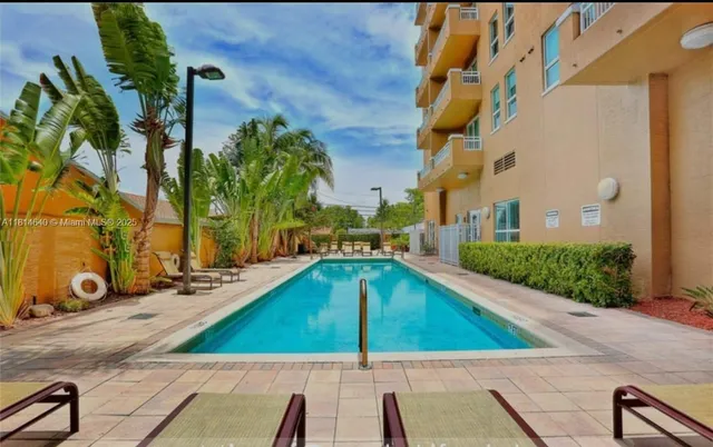 a view of a pool with chairs