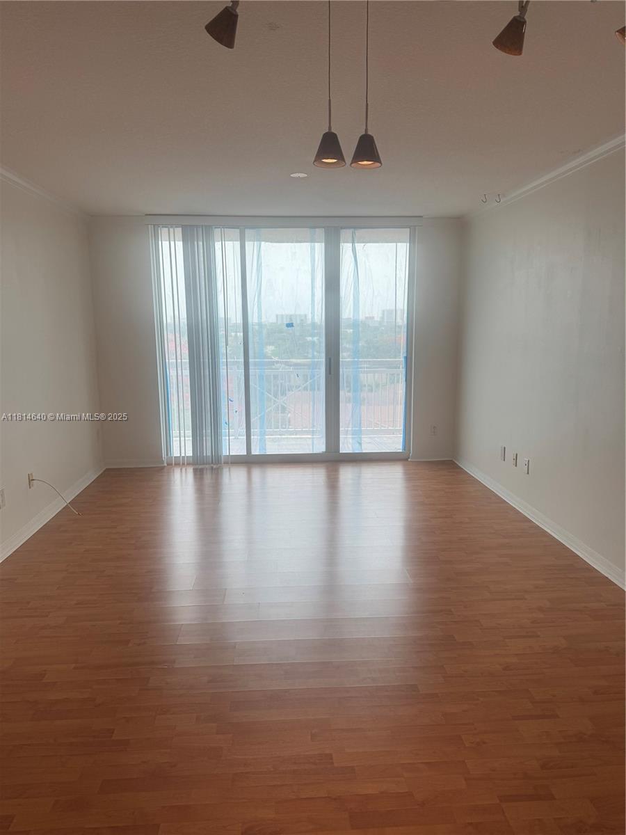 2665 Southwest 37th Avenue, Unit 601 Miami, FL 33133 - Photo 3 of 7 an empty room with wooden floor and windows