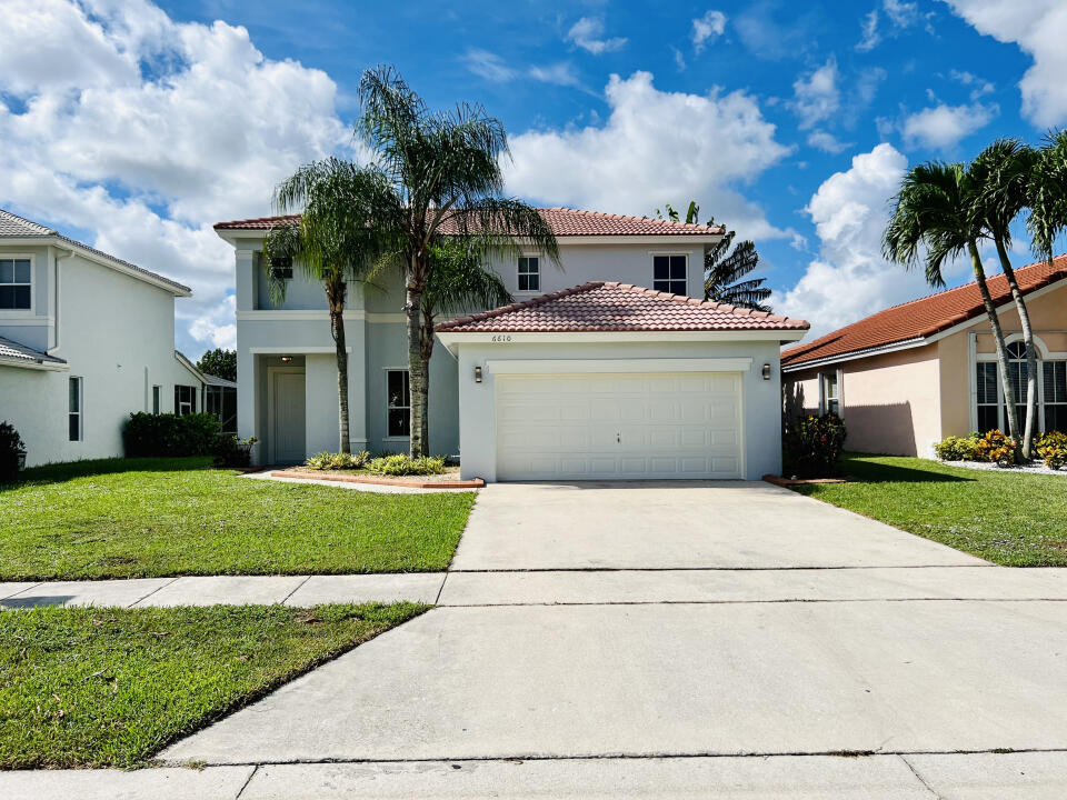 6610 Windmill Way Greenacres, FL 33413 - Photo 1 of 40 a house view with a garden space