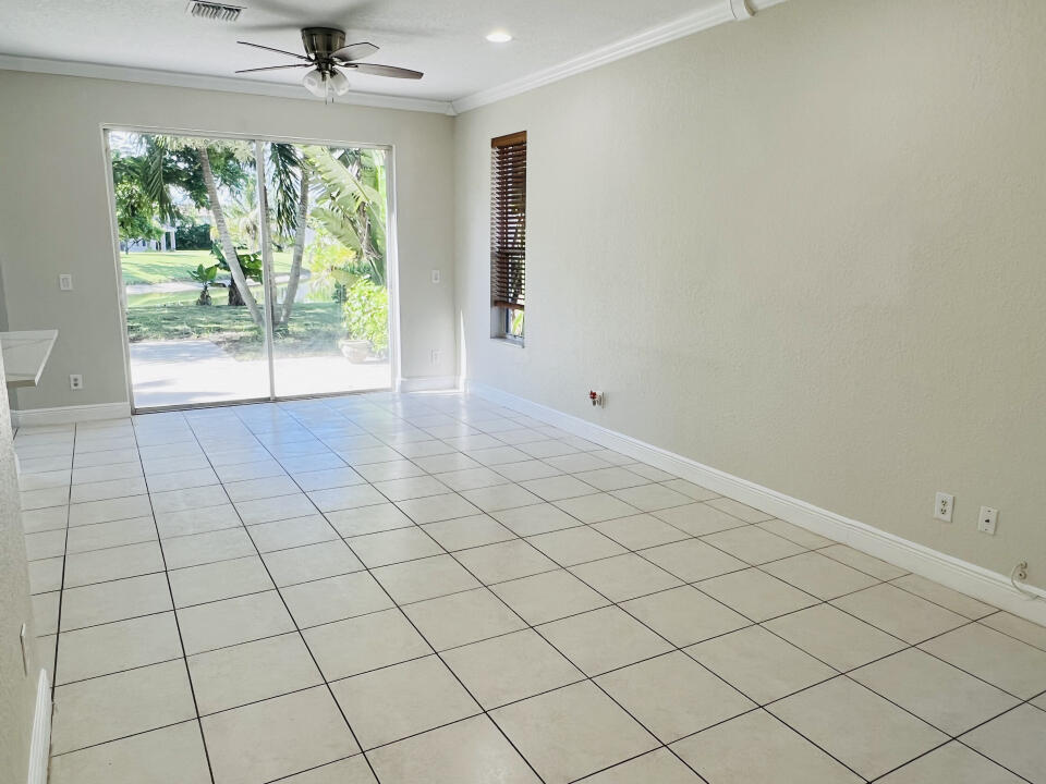 6610 Windmill Way Greenacres, FL 33413 - Photo 13 of 40 an empty room with windows