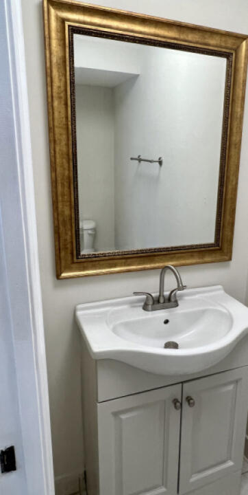 6610 Windmill Way Greenacres, FL 33413 - Photo 14 of 40 a bathroom with a sink and a mirror