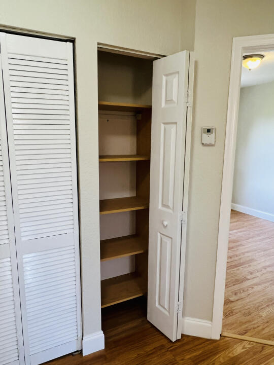 6610 Windmill Way Greenacres, FL 33413 - Photo 17 of 40 a view of walk in closet with empty racks