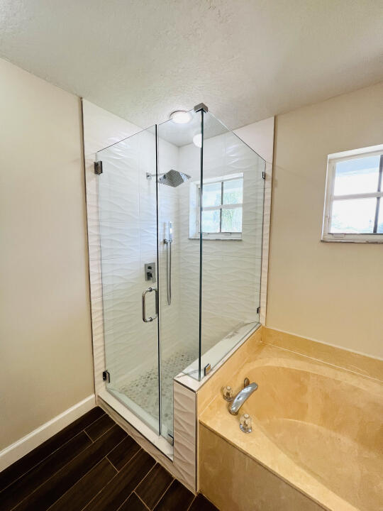 6610 Windmill Way Greenacres, FL 33413 - Photo 26 of 40 a bathroom with a tub and a shower