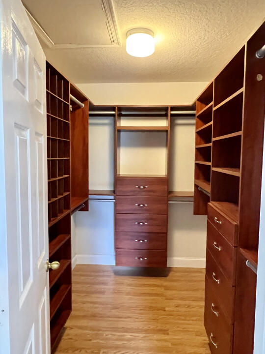 6610 Windmill Way Greenacres, FL 33413 - Photo 28 of 40 a view of walk in closet with clothes and shoes