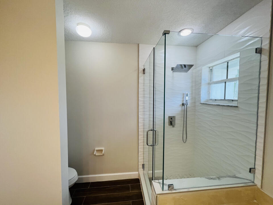 6610 Windmill Way Greenacres, FL 33413 - Photo 29 of 40 a bathroom with a shower and a sink