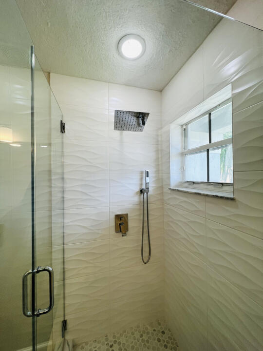 6610 Windmill Way Greenacres, FL 33413 - Photo 30 of 40 a bathroom with a shower