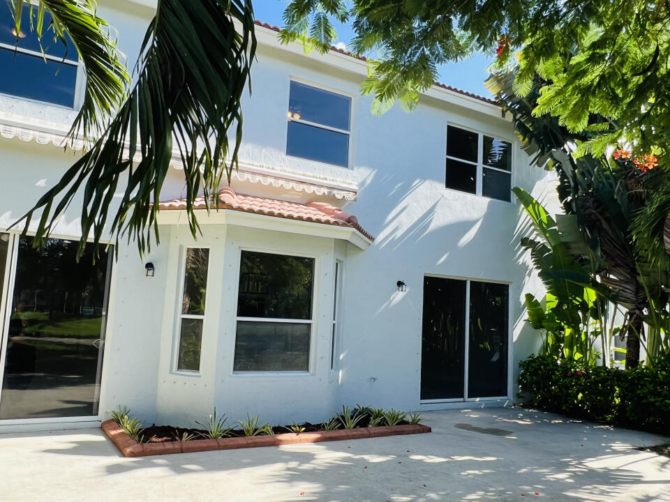 6610 Windmill Way Greenacres, FL 33413 - Photo 35 of 40 a front view of a house with a tree