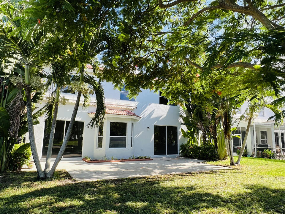 6610 Windmill Way Greenacres, FL 33413 - Photo 36 of 40 a view of a house with a yard and tree s