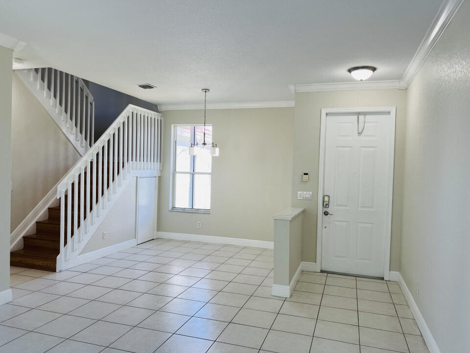 6610 Windmill Way Greenacres, FL 33413 - Photo 5 of 40 a view of an empty room and stairs