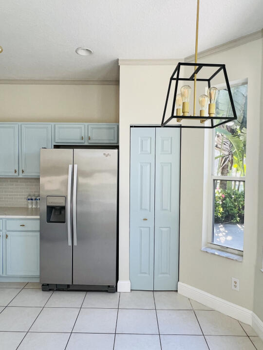 6610 Windmill Way Greenacres, FL 33413 - Photo 9 of 40 a kitchen with a refrigerator and window