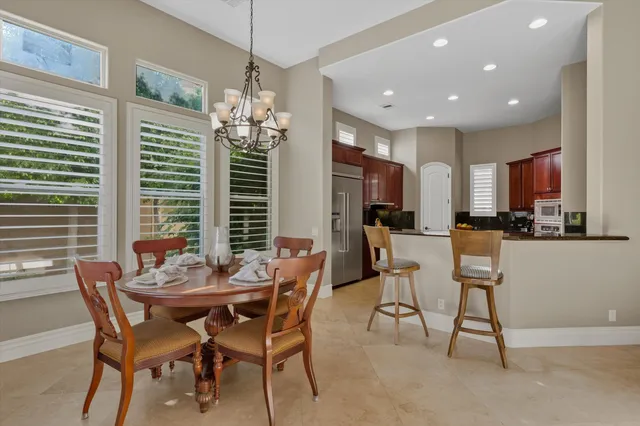 a kitchen with stainless steel appliances granite countertop a refrigerator and a stove top oven with wooden floor