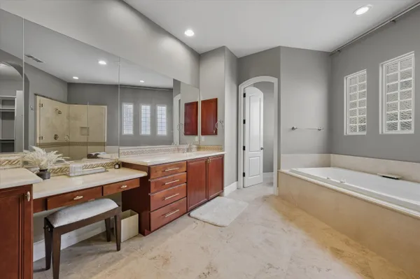 a spacious bathroom with a granite countertop sink and a mirror