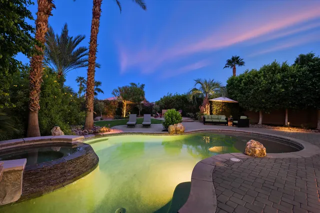 a view of a swimming pool and lounge chairs