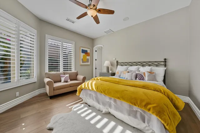 a bedroom with two beds and a couch