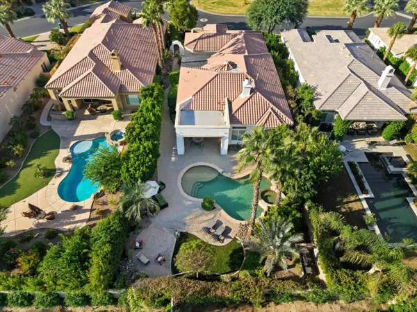 a view of a house with pool and sitting area