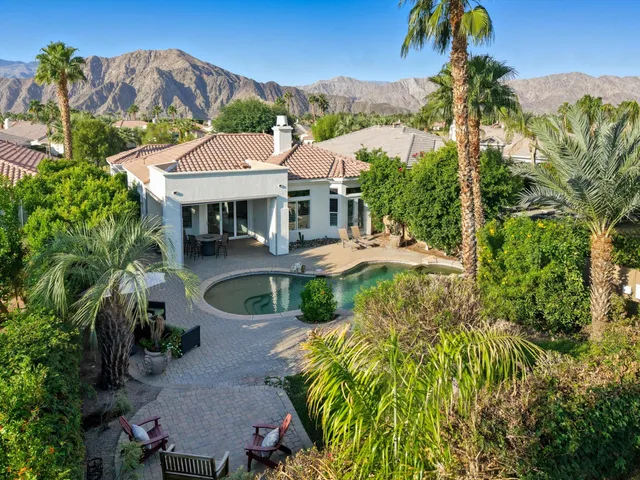 an aerial view of a house with a yard and potted plants
