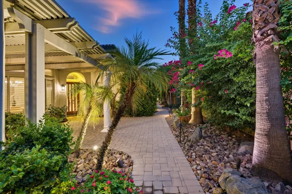 a view of a pathway with a flower garden