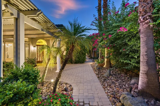 a view of a pathway with a flower garden