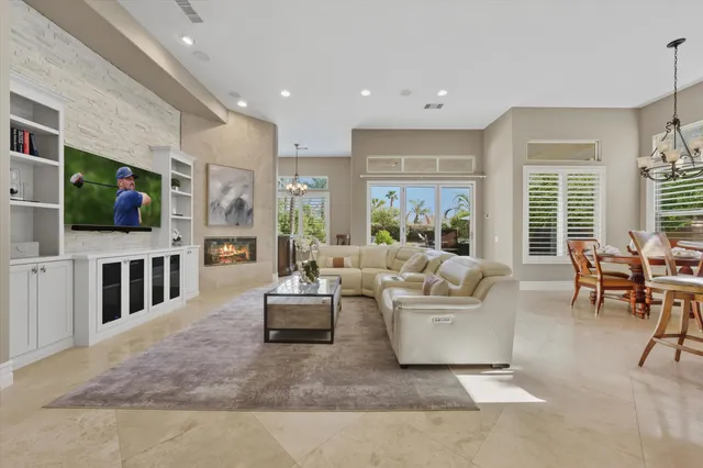 a living room with furniture a fireplace and a kitchen view