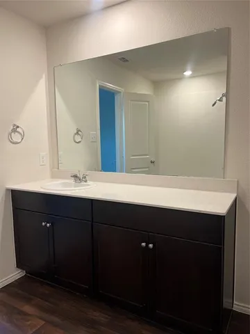 a bathroom with a sink vanity and mirror