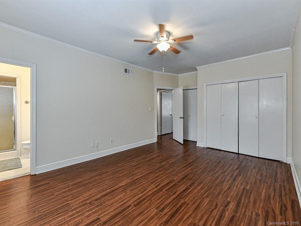 5925 Quail Hollow Road, Unit G Charlotte, NC 28210 - Photo 14 of 19 a view of an empty room with wooden floor