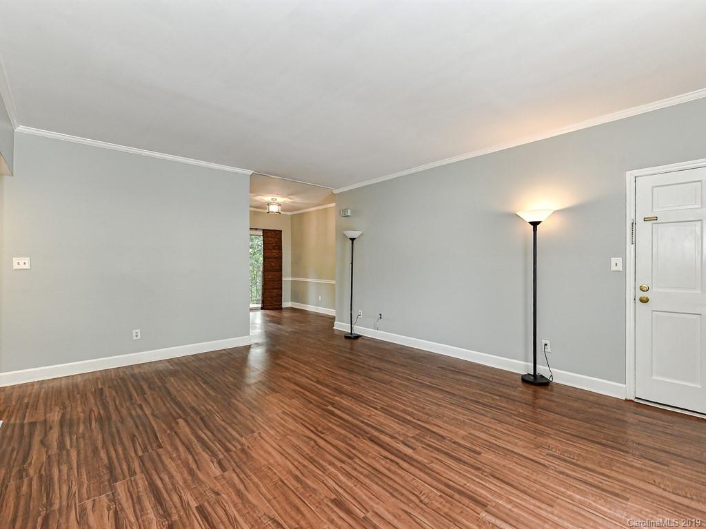 5925 Quail Hollow Road, Unit G Charlotte, NC 28210 - Photo 4 of 19 an empty room with wooden floor and windows