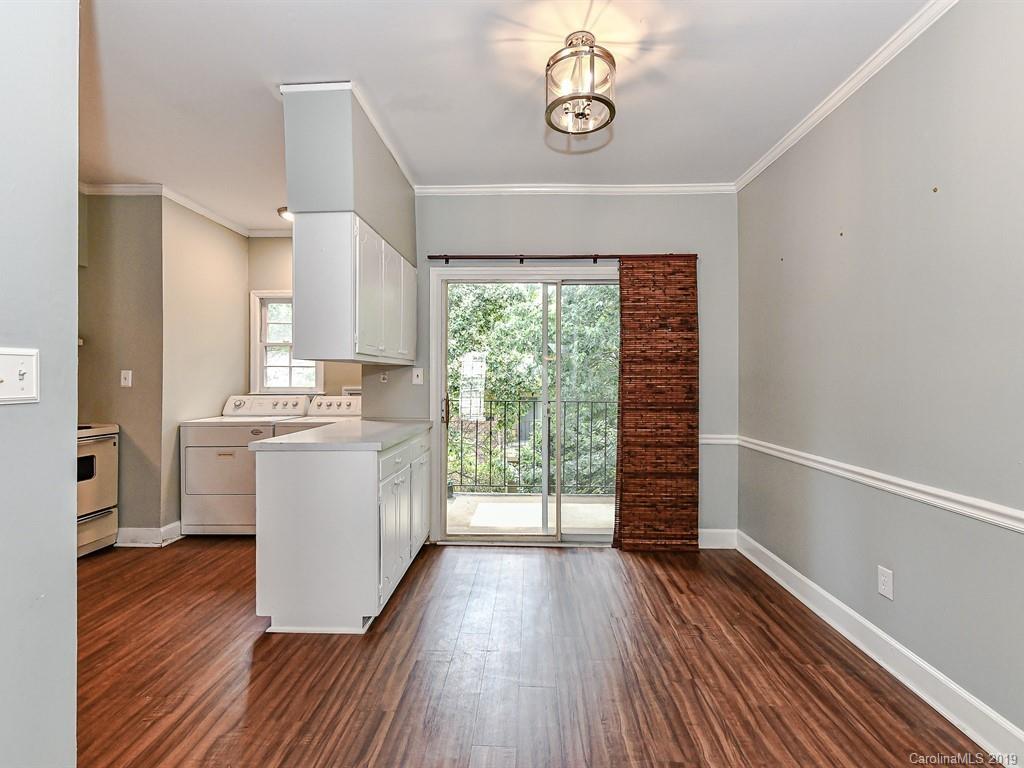 5925 Quail Hollow Road, Unit G Charlotte, NC 28210 - Photo 5 of 19 a kitchen with wooden floors and white walls
