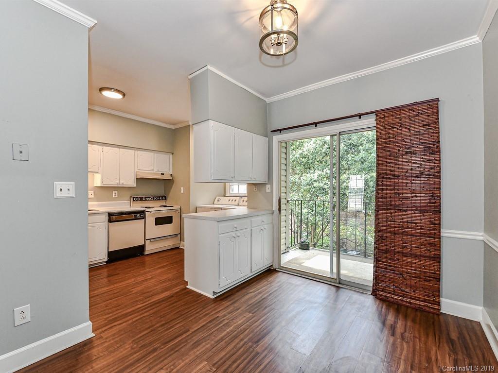 5925 Quail Hollow Road, Unit G Charlotte, NC 28210 - Photo 7 of 19 a kitchen with wooden floors and white appliances