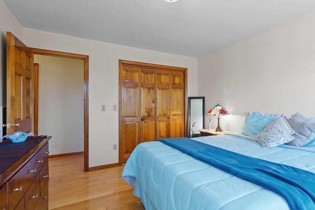 169 Wallace Hill Road Townsend, MA 01469 - Photo 17 of 42 a bedroom with a bed and a dresser