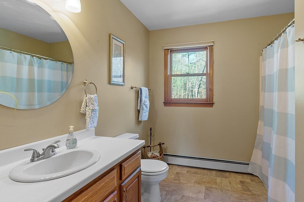 169 Wallace Hill Road Townsend, MA 01469 - Photo 18 of 42 a bathroom with a granite countertop sink toilet and a mirror