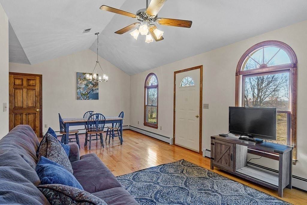 169 Wallace Hill Road Townsend, MA 01469 - Photo 21 of 42 a living room with furniture and a flat screen tv