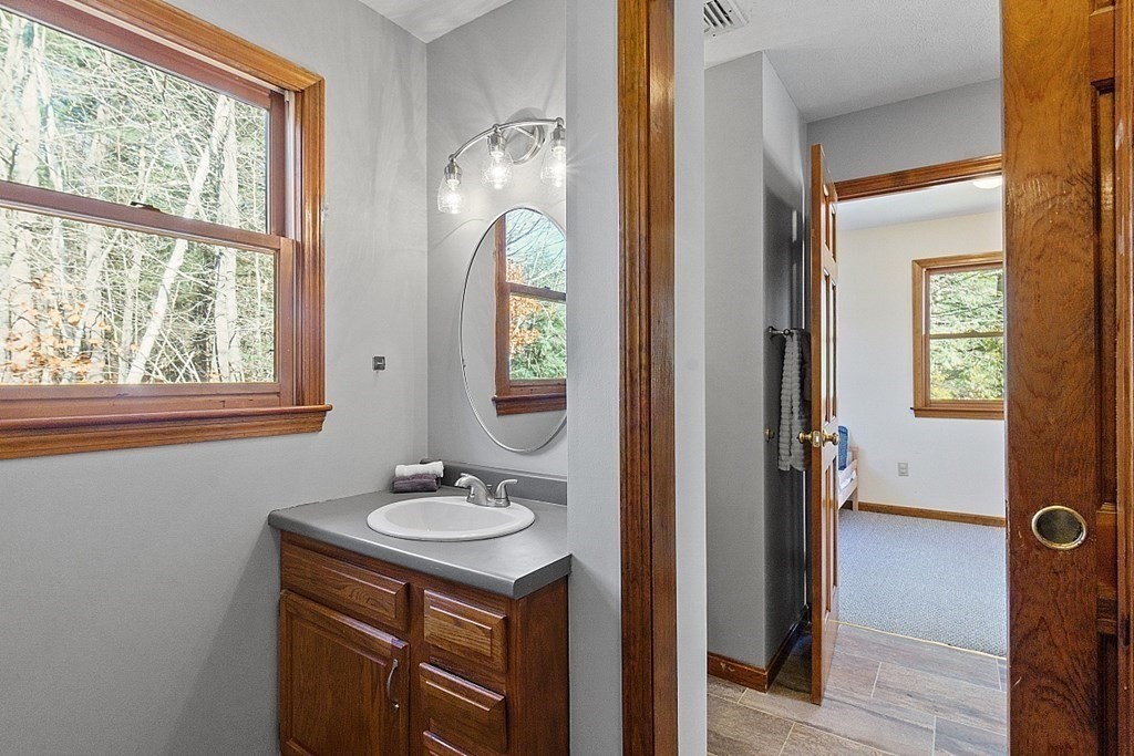 169 Wallace Hill Road Townsend, MA 01469 - Photo 25 of 42 a bathroom with a sink a mirror and a window