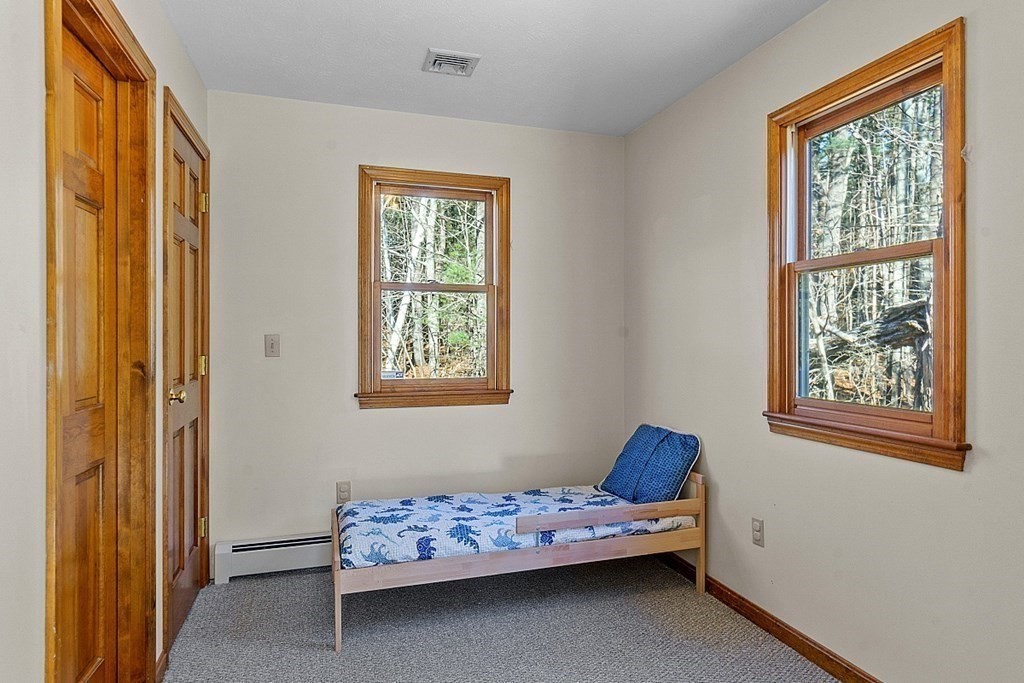 169 Wallace Hill Road Townsend, MA 01469 - Photo 32 of 42 a bedroom with a bed and window